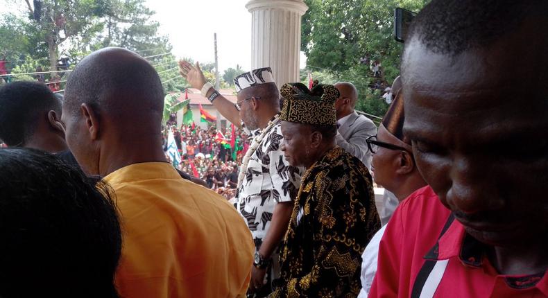 IPOB leader, Nnamdi Kanu waves at Biafran protesters in front of his Umuahia home on Wednesday, June 28, 2017