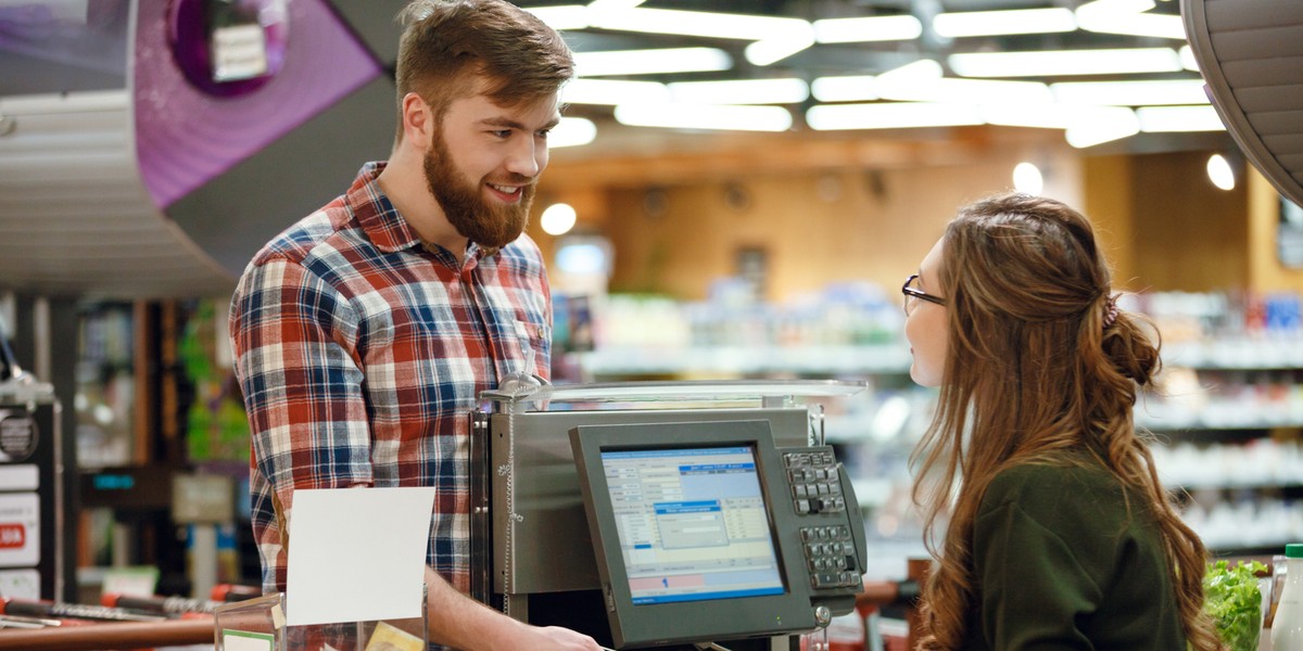 Cashier lady create payment with mobile phone app.