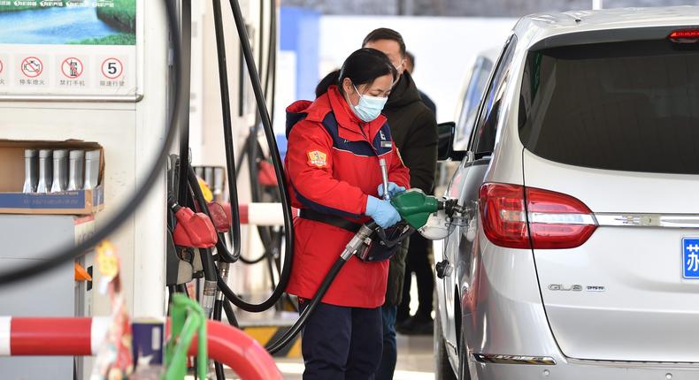 A staff member fills up a car at a gas station in Nanjing, Jiangsu Province, China.CFOTO/Future Publishing via Getty Images