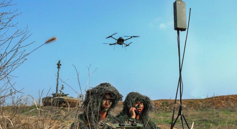 Militaries are gearing up for a new kind of warfare in which soldiers battle with drone swarms. Pictured, soldiers direct a drone in Anhui province, China.Getty Images