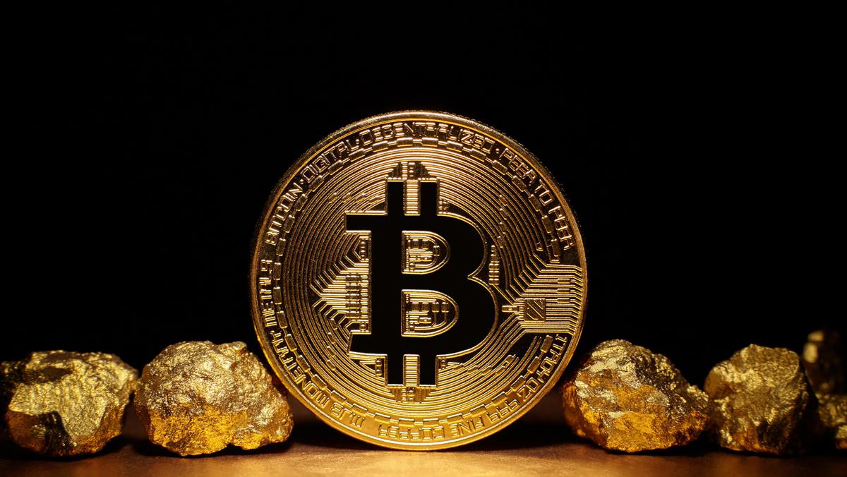 Golden Bitcoin Coin and mound of gold on black background