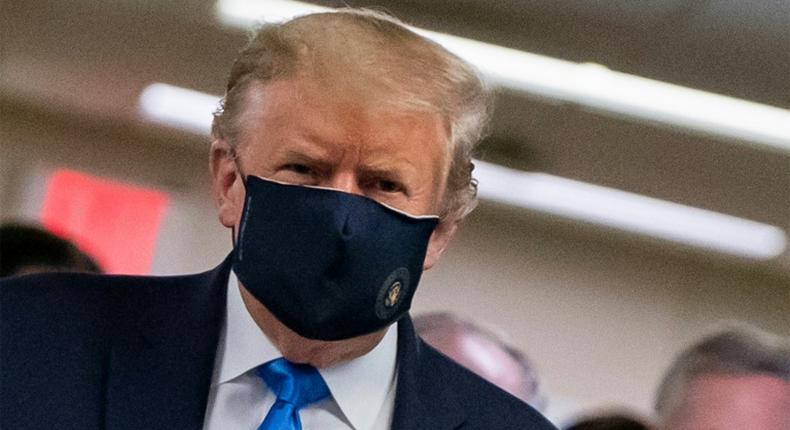 President Donald Trump makes a rare appearance in a mask as part of a new attempt to restore his standing with Americans over the handling of the coronavirus pandemic