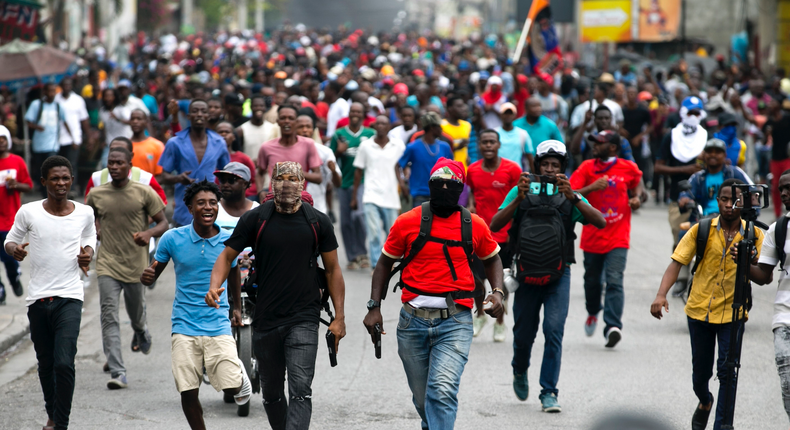 Armed off-duty police officers protest over police pay and working conditions, in Port-au-Prince, Haiti, Sunday, Feb. 23, 2020.