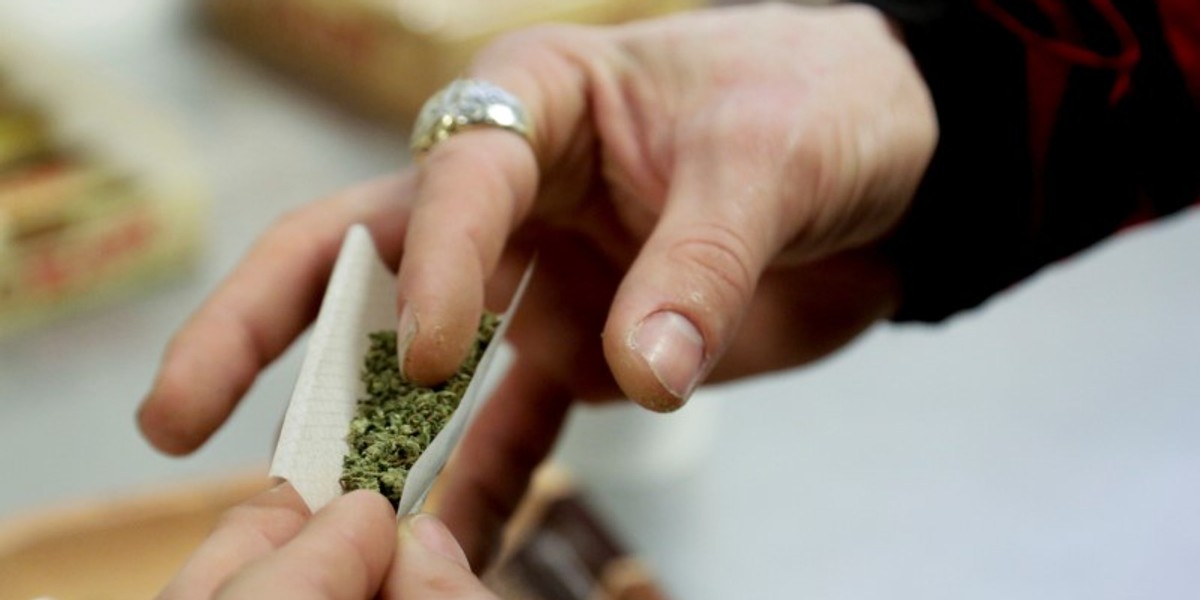 A participant practices rolling a joint at the Cannabis Carnivalus 4/20 event in Seattle.