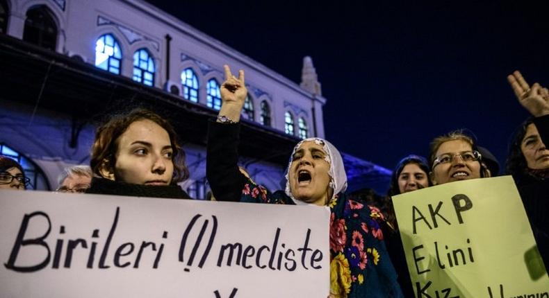 Women shout slogans and hold placards reading Rape is a human crime (L) and AKP get your hands off our children during a demonstration in Istanbul on November 18, 2016