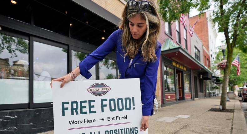 Coleen Piteo, director of marketing at Yours Truly restaurant, puts out a sign for hiring, Thursday, June 3, 2021, in Chagrin Falls, Ohio.
