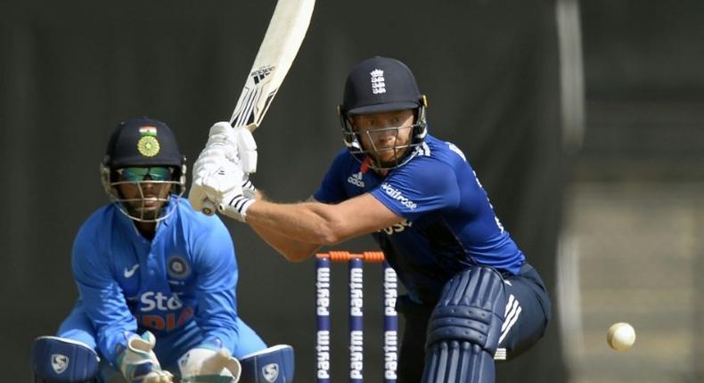 England player Jonny Bairstow (R) makes a mark both in front of and behind the wicket
