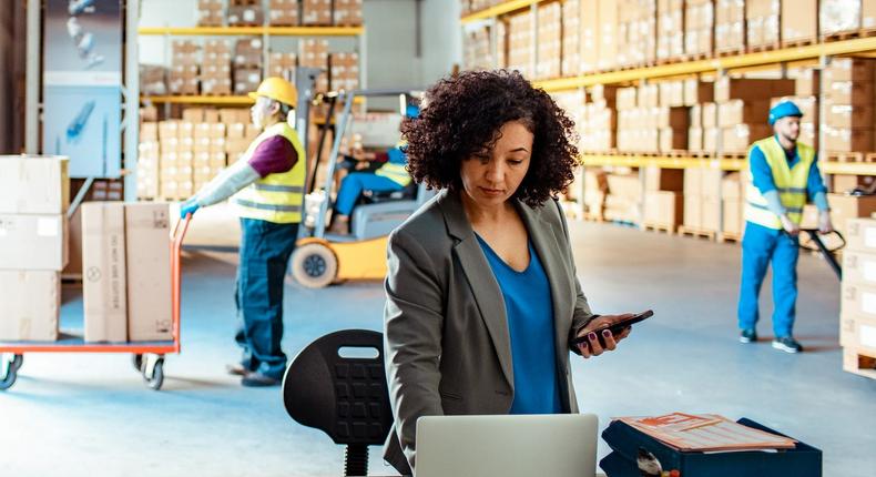 A woman works in a warehouse setting.