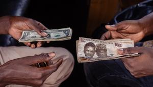 A customer exchanges Nigerian 1000 Naira banknotes for US dollar banknotes with a street currency dealer at a market in Lagos, Nigeria, on Monday, Sept. 25, 2023.  [Getty Images]