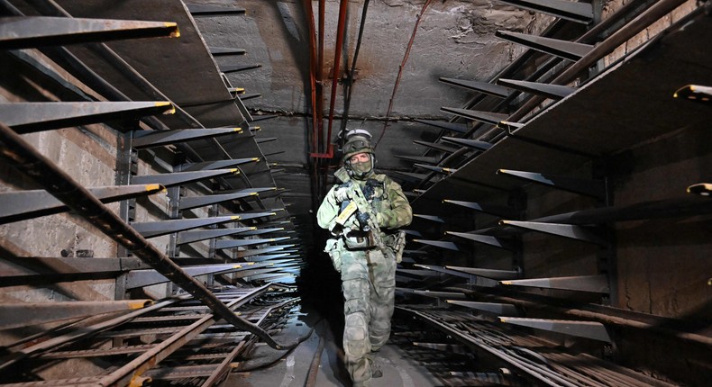 A Russian serviceman inspects an underground tunnel under the Azovstal steel plant in Mariupol, June 13, 2022