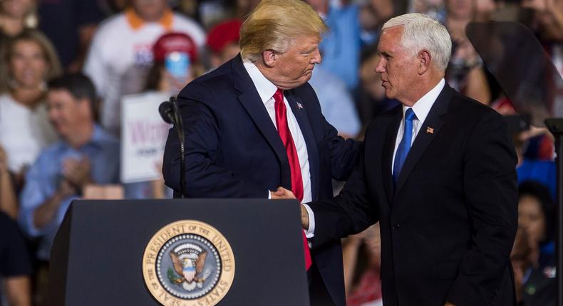 Then-President Donald Trump shakes then-Vice President Mike Pence's hand after a 2019 rally.Zach Gibson/Getty Images