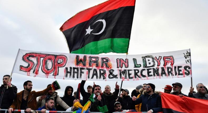 Protesters hold a banner reading Stop war in Libya, Haftar and mercenaries during a protest near the chancellery during the Peace summit on Libya at the Chancellery in Berlin on January 19, 2020