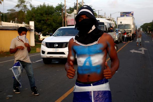 A masked protester is pictured during a protest against President Daniel Ortega's government in Leon