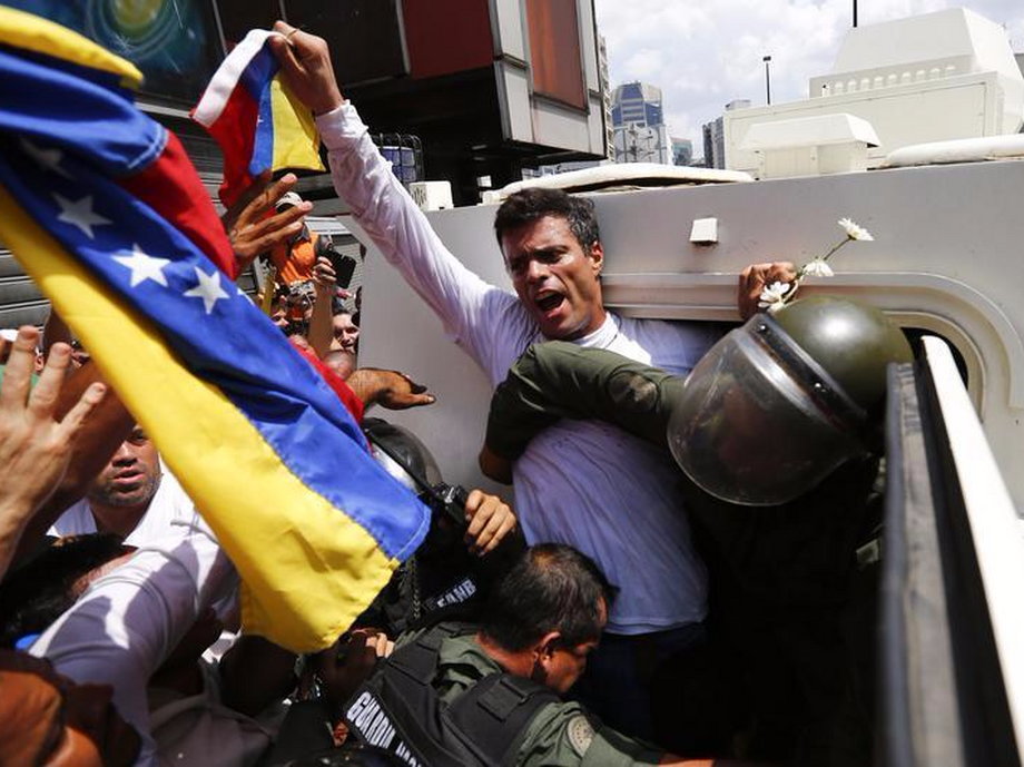 Venezuelan opposition leader Leopoldo Lopez gets into an armored vehicle in Caracas.
