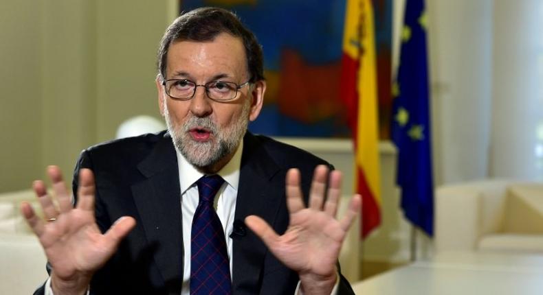 Spanish Prime Minister Mariano Rajoy gestures during an AFP interview at La Moncloa Palace in Madrid