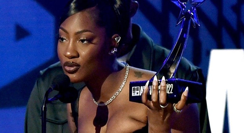 Tems accepting her award at the 2022 BET