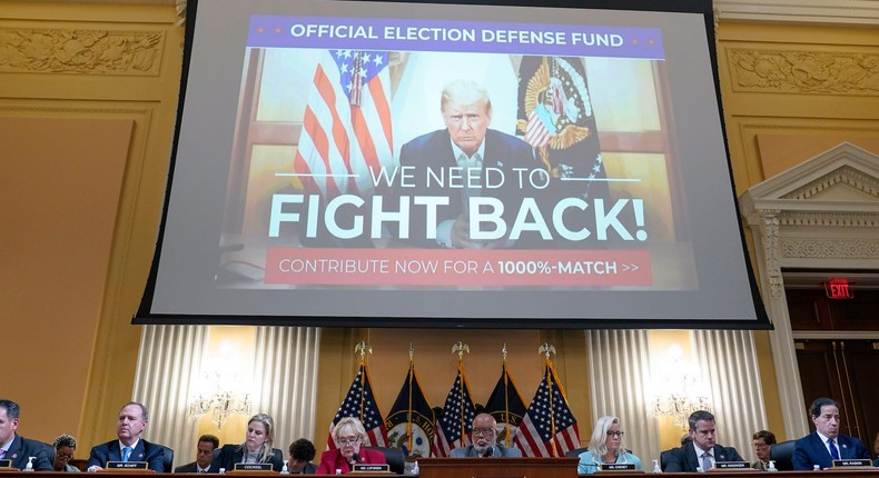 Lawmakers listen as an image of a Trump campaign donation banner is shown behind them during a House January 6 committee hearing.