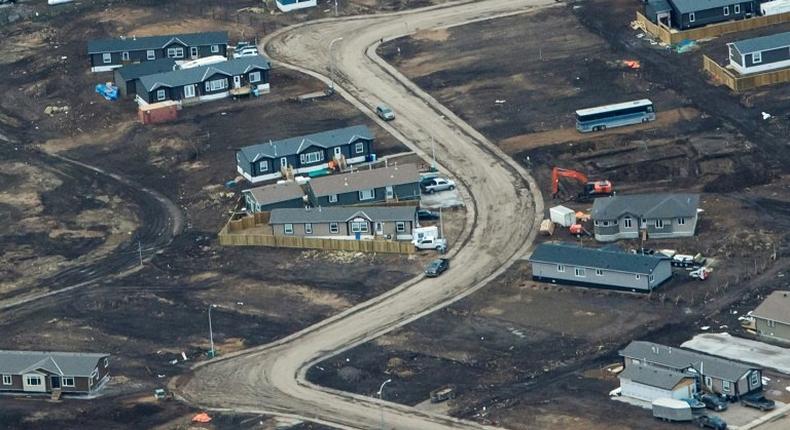 Aerial view of a residential neighborhood in Fort McMurray, Canada, where some homes have been rebuilt but many have not, one year after a massive forest fire