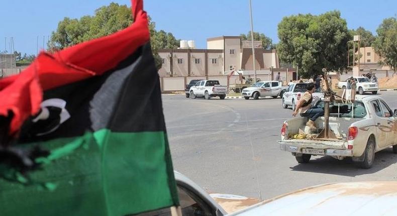 Forces aligned with Libya's new unity government advance along a road in Sirte, June 10, 2016. 