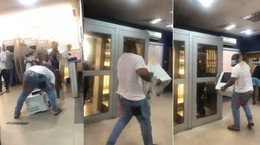 Angry man storms bank, carries printer over refusal to refund his money (video)