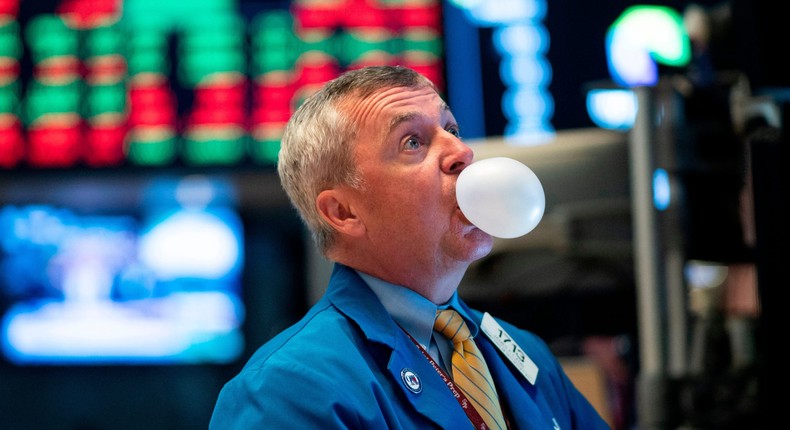 A trader blows bubble gum during the opening bell at the New York Stock Exchange (NYSE) on August 1, 2019, in New York City.