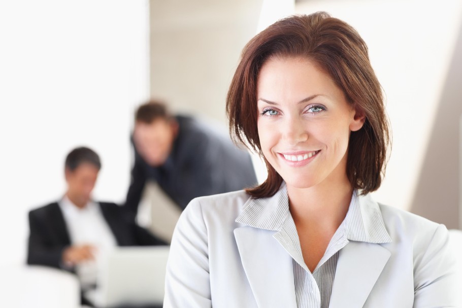 A Happy business woman with other colleagues in the background