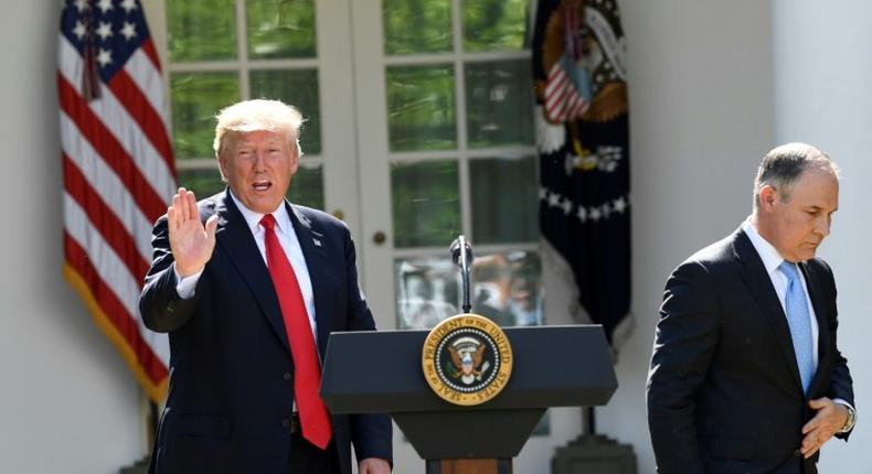 The head of the Environmental Protection Agency Scott Pruitt (R) and US President Donald Trump speak to the media in the Rose Garden of the White House