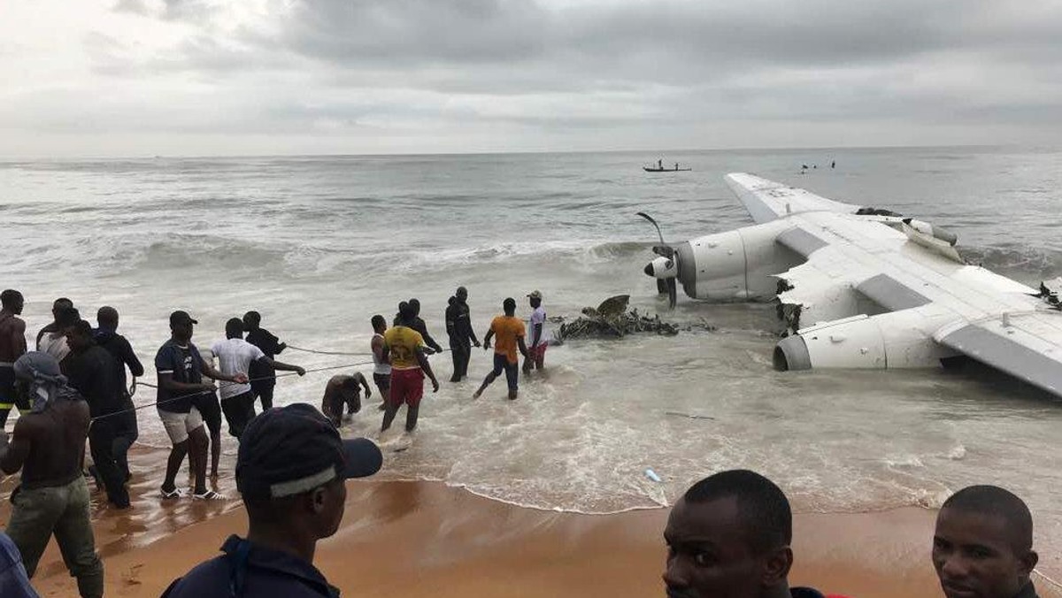 People pull the wreckage of a propeller-engine cargo plane after it crashed in the sea near the international airport in Ivory Coast's main city, Abidjan