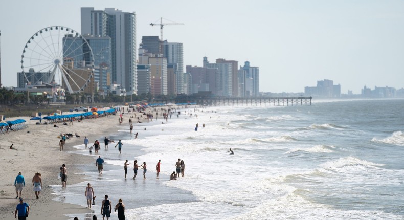 People walk along the beach the morning of May 29, 2021 in Myrtle Beach, South Carolina.