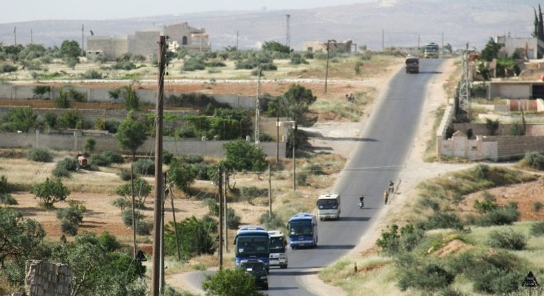 Syrian civilians and rebels, who were evacuated from the Qabun district in northeast Damascus, arrive by bus at a temporary camp in the northern countryside of Idlib province on May 15, 2017