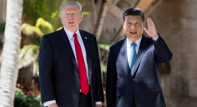 Chinese President Xi Jinping (right) waves to the press as he walks with US President Donald Trump at the Mar-a-Lago estate in West Palm Beach, Florida, April 7, 2017