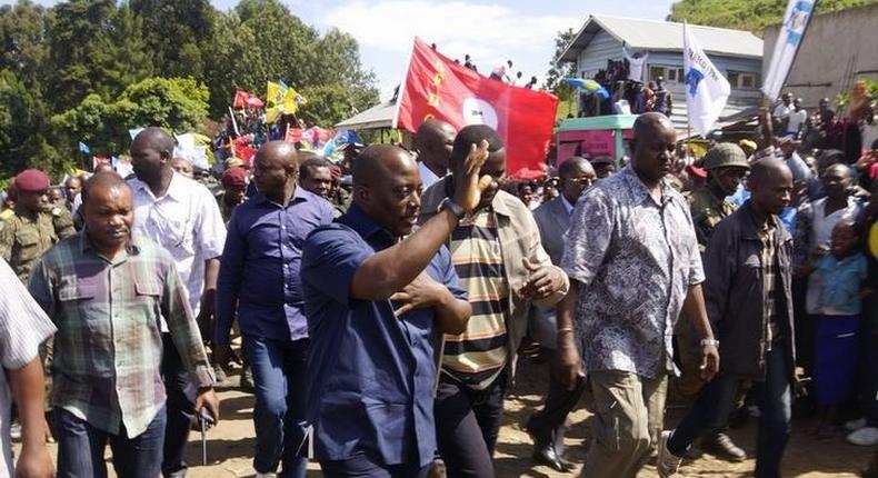 Democratic Republic of Congo's President Joseph Kabila (front C) waves as he walks in a file photo. REUTERS/Kenny Katombe