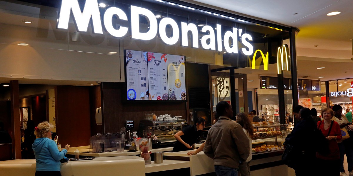 Customers placing orders at a McDonald's in a shopping mall.