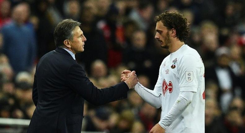 Southampton's manager Claude Puel shakes hands with striker Manolo Gabbiadini during their English League Cup final match against Manchester United, at Wembley stadium in London, on February 26, 2017
