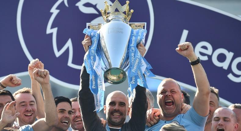 Manchester City manager Pep Guardiola lifts the Premier League trophy