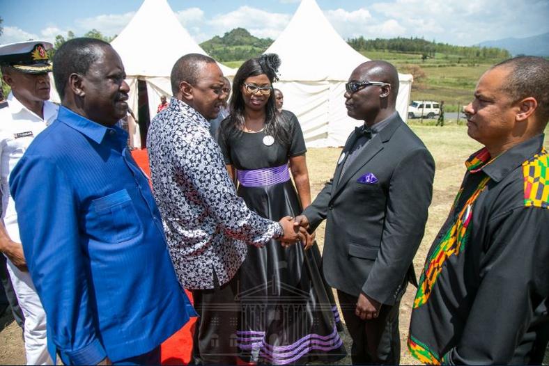 Raila Odinga and President Uhuru Keyatta arrive at Dr. Robert Ouko Primary School in Koru, Kisumu County for the funeral of the late Bruce Dominic Odhiambo Were 