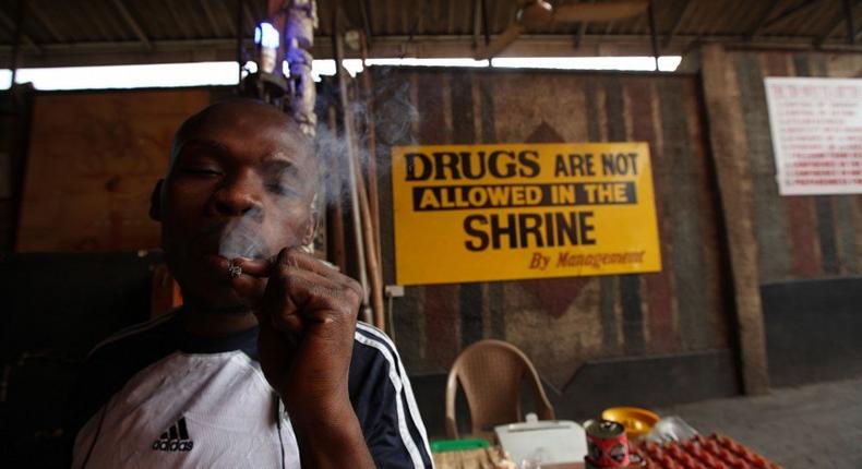 An unidentified man smokes weed at the New Afrikan Shrine in Lagos