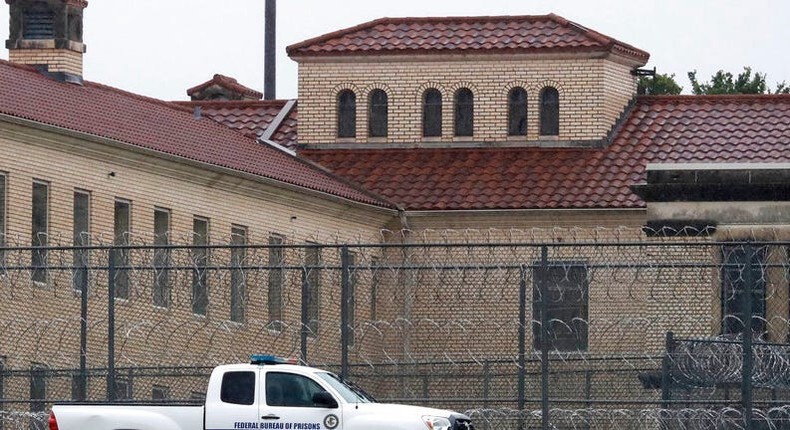 A Federal Bureau of Federal Prisons truck drives past barbed wire fences at the Federal Medical Center prison in Fort Worth, Texas, in May 2020.