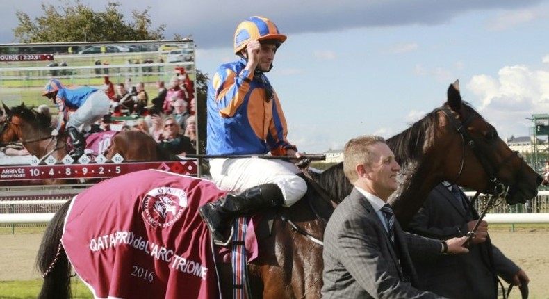 Britain's Ryan-Lee Moore on his horse 'Found' celebrates winning the 95th Prix de l'Arc de Triomphe horse race at the Chantilly racecourse, northern France, on October 2, 2016