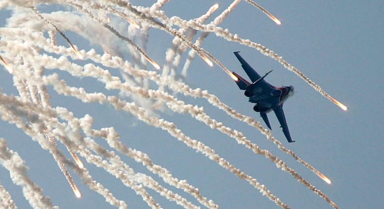 'Russian Knights' air force group member flies over Monino airfield on his jet SU-27 during an aerial show to commemorate the 95th anniversary of Russian Air Forces outside Moscow, August 11, 2007REUTERS/Denis Sinyakov