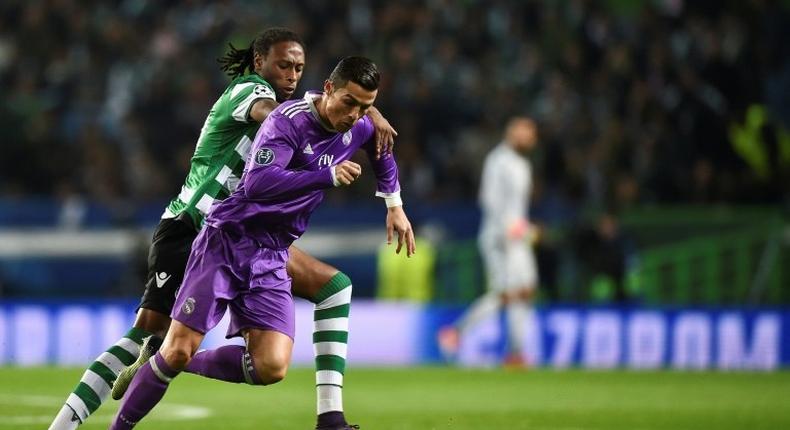 Real Madrid's forward Cristiano Ronaldo (R) clashes with Sporting's defender Ruben Semedo on November 22, 2016