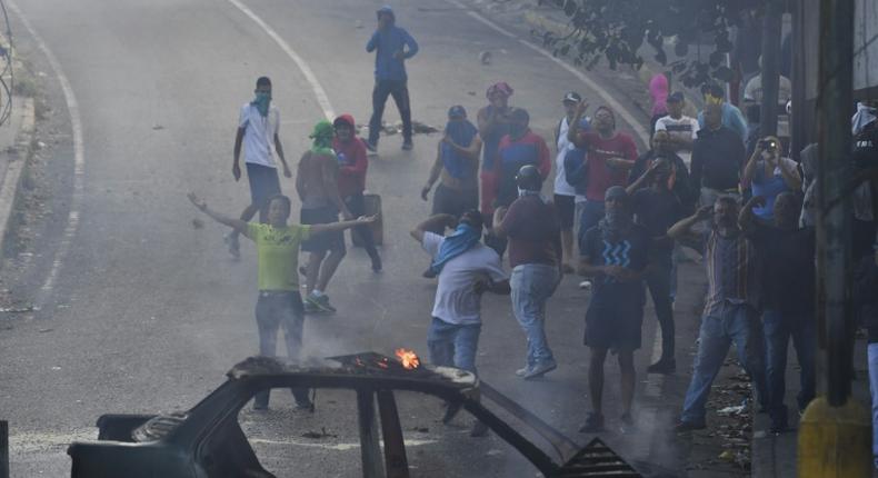 Venezuelans protest near the Cotiza National Guard headquarters in Caracas, where a group of soldiers were arrested on Monday after rising up against President Nicolas Maduro