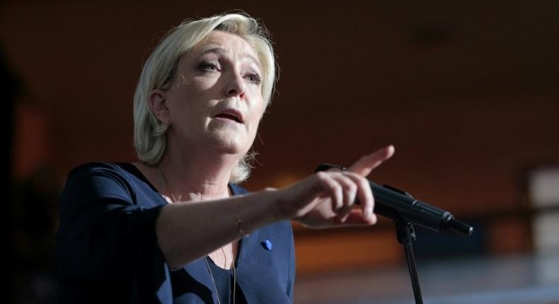 French presidential election candidate for the far-right Front National (FN) party Marine Le Pen gestures as she delivers a speech during a campaign meeting at the Palais des Congres in Ajaccio on the island of Corsica on April 8, 2017