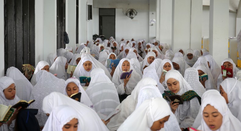 Muslim students from Ar-Raudlatul Hasanah boarding school read Koran during the first day of the holy fasting month of Ramadan at a mosque in Medan