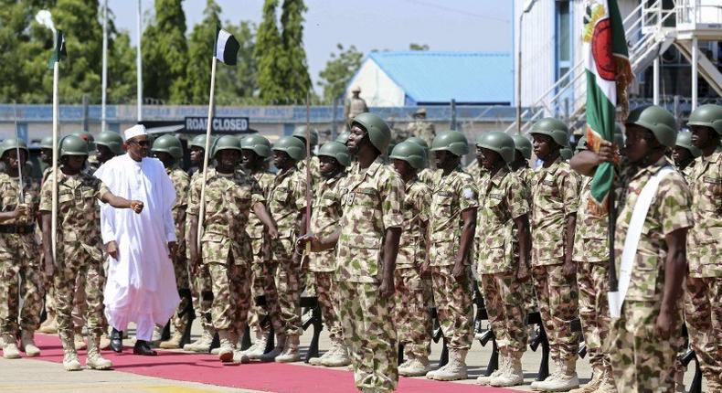 Nigerian President Muhammadu Buhari inspects a guard of honour during his visit to Nigerian troops in Yola, Adamawa, Nigeria November 13, 2015 