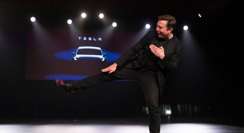 Elon Musk kick shoes Tesla smaller