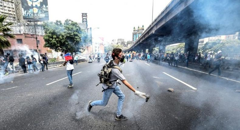 Venezuelan opposition activists chanting No more dictatorship! hurled stones at National Guard riot police who blocked them from marching on central Caracas