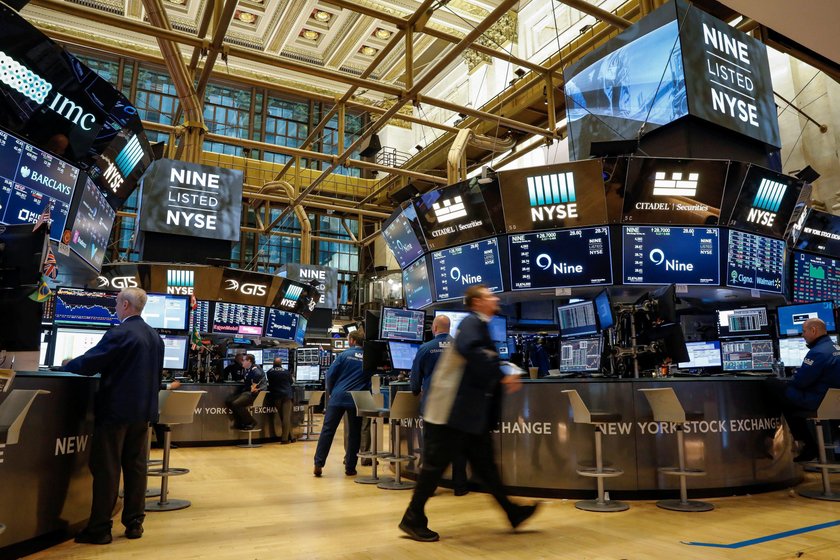 Traders work on the floor of the NYSE in New York