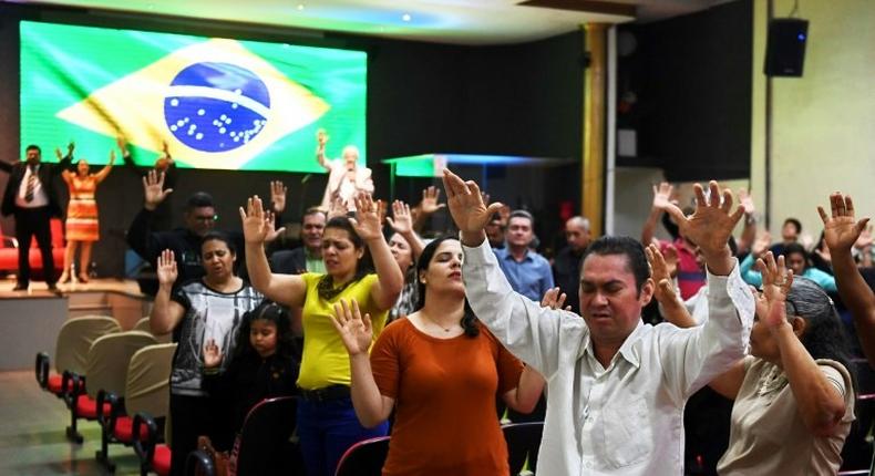 Faithful pray at an evangelical church in Brasilia for the recovery of the health of Brazilian right-wing presidential candidate Jair Bolsonaro, who suffered a knife attack during the campaign