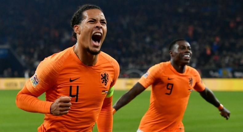 Netherlands' defender Virgil van Dijk (L) celebrates scoring in the 91st-minute to seal a 2-2 draw against Germany on Monday as the Dutch advance to the semi-finals of the Nations League at the expense of world champions France.